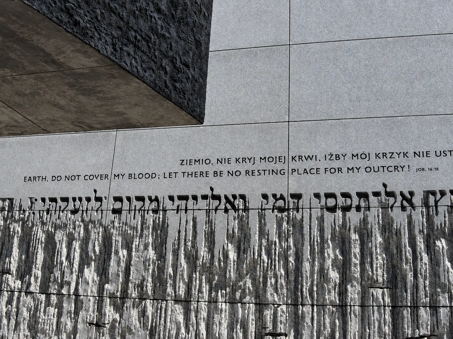 Memorial wall with inscriptions at the former Bełżec extermination camp