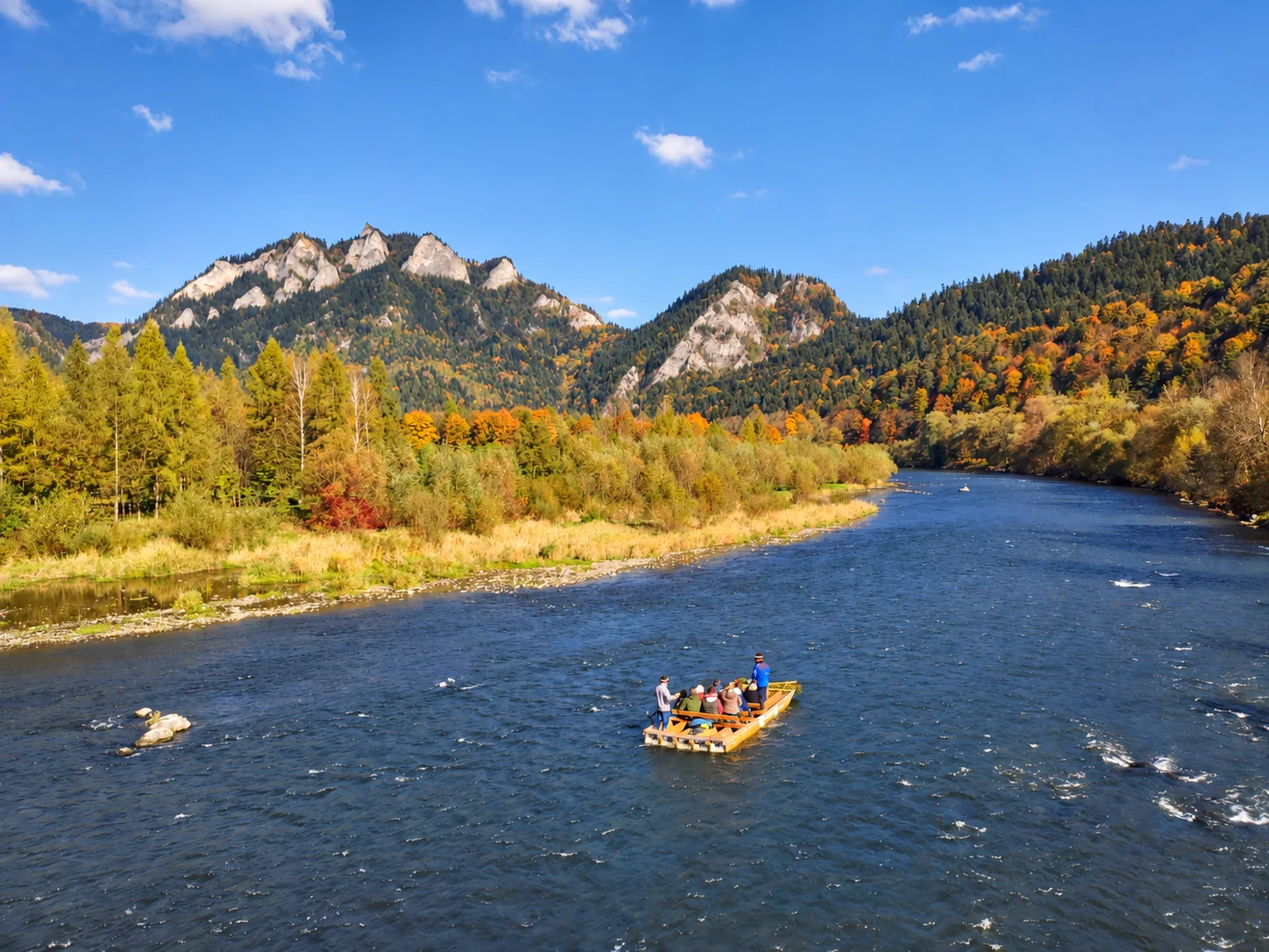 Traditional wooden rafting on the Dunajec River beneath the Pieniny Mountains