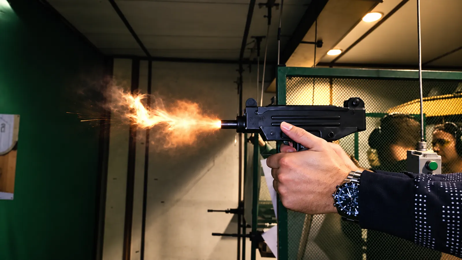 Uzi-style firearm being fired at an indoor shooting range near Krakow