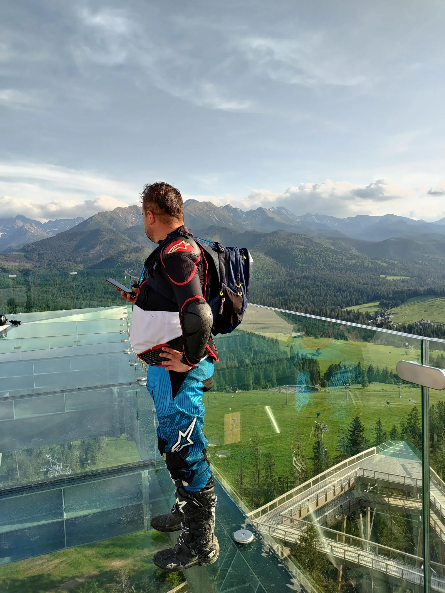 Visitor standing on the SkyWalk platform above the Tatra landscape