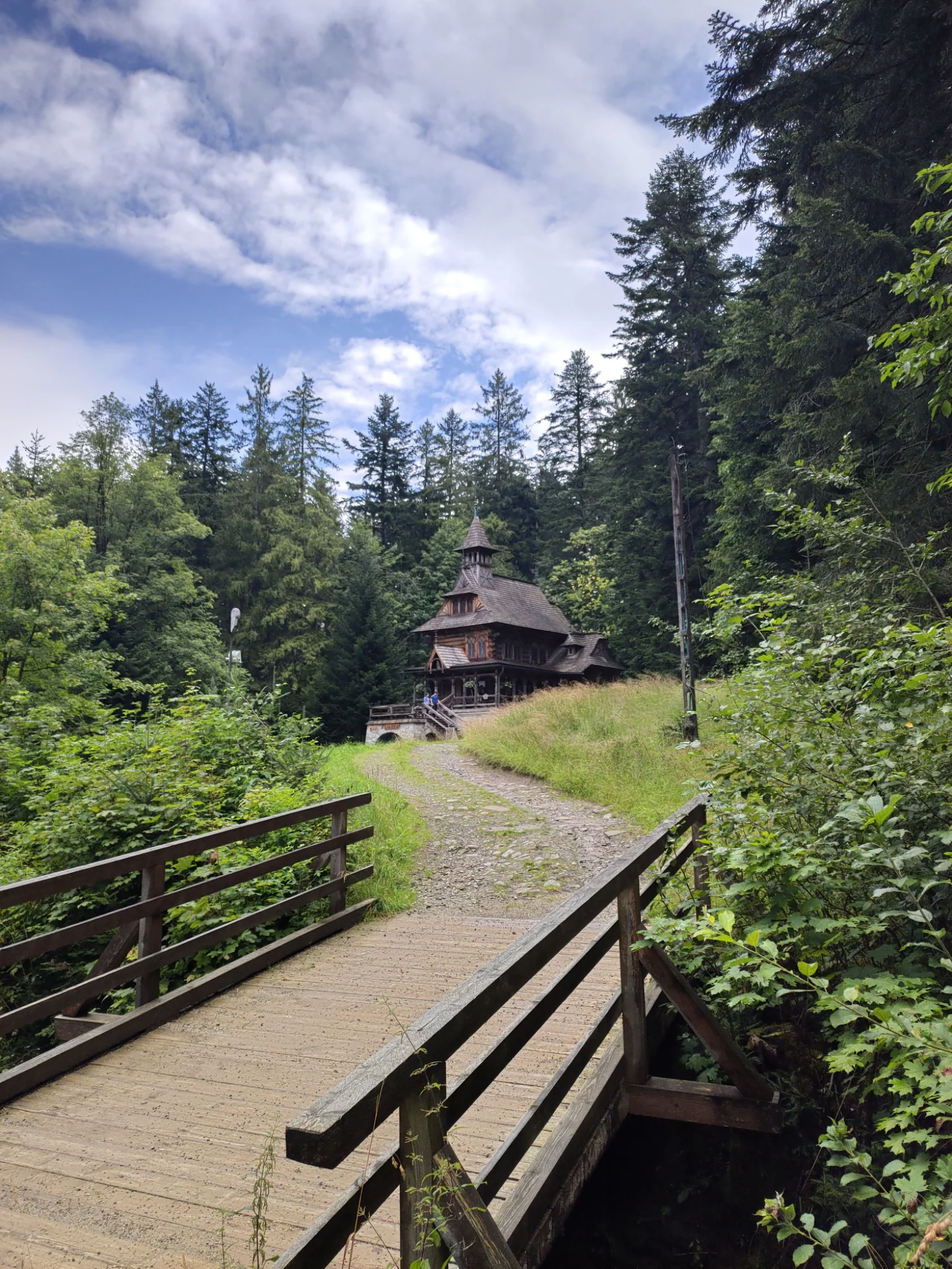 Traditional wooden chapel reached by a forest path near Zakopane