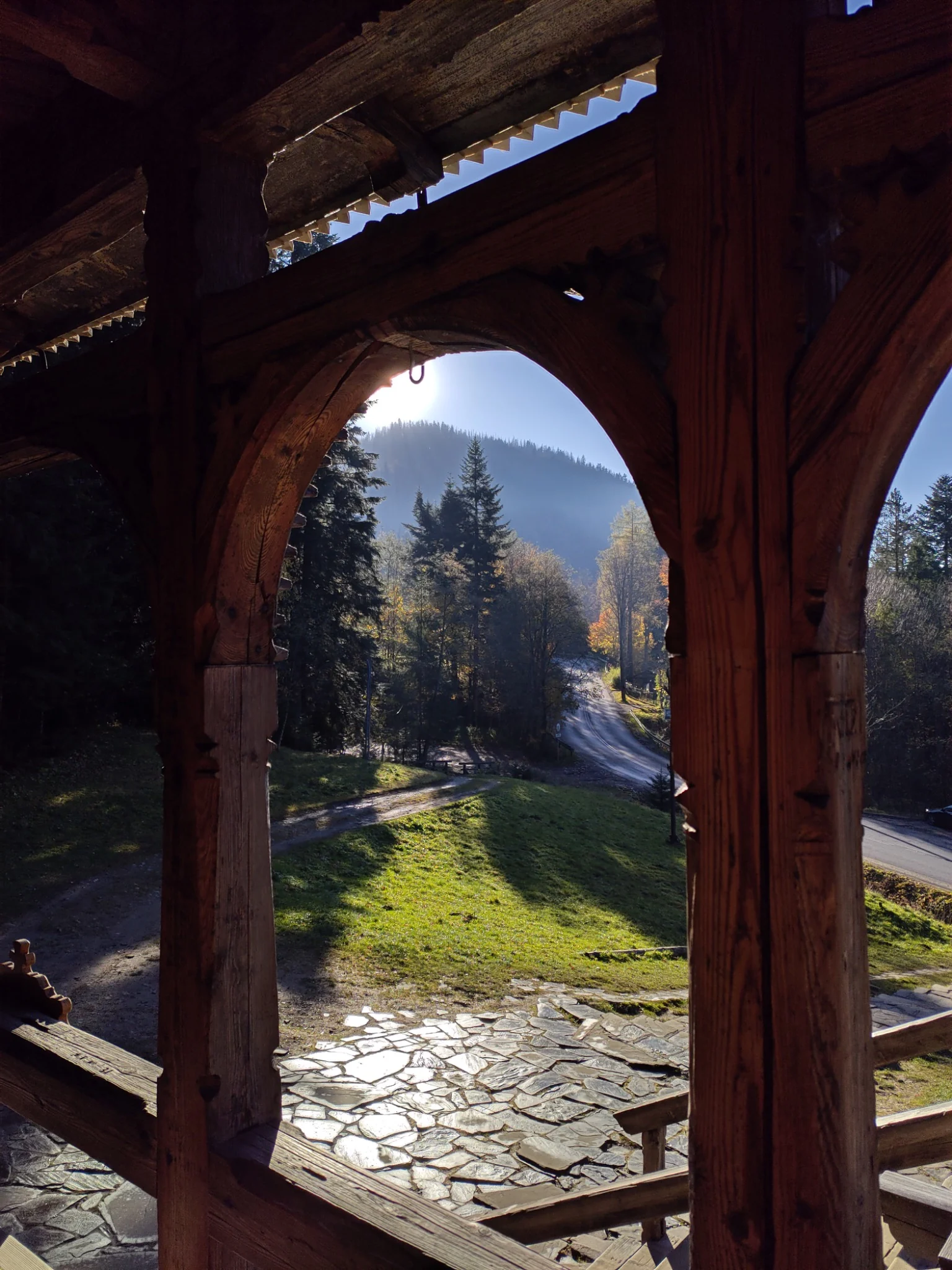 View through carved wooden arches of a traditional chapel near Zakopane
