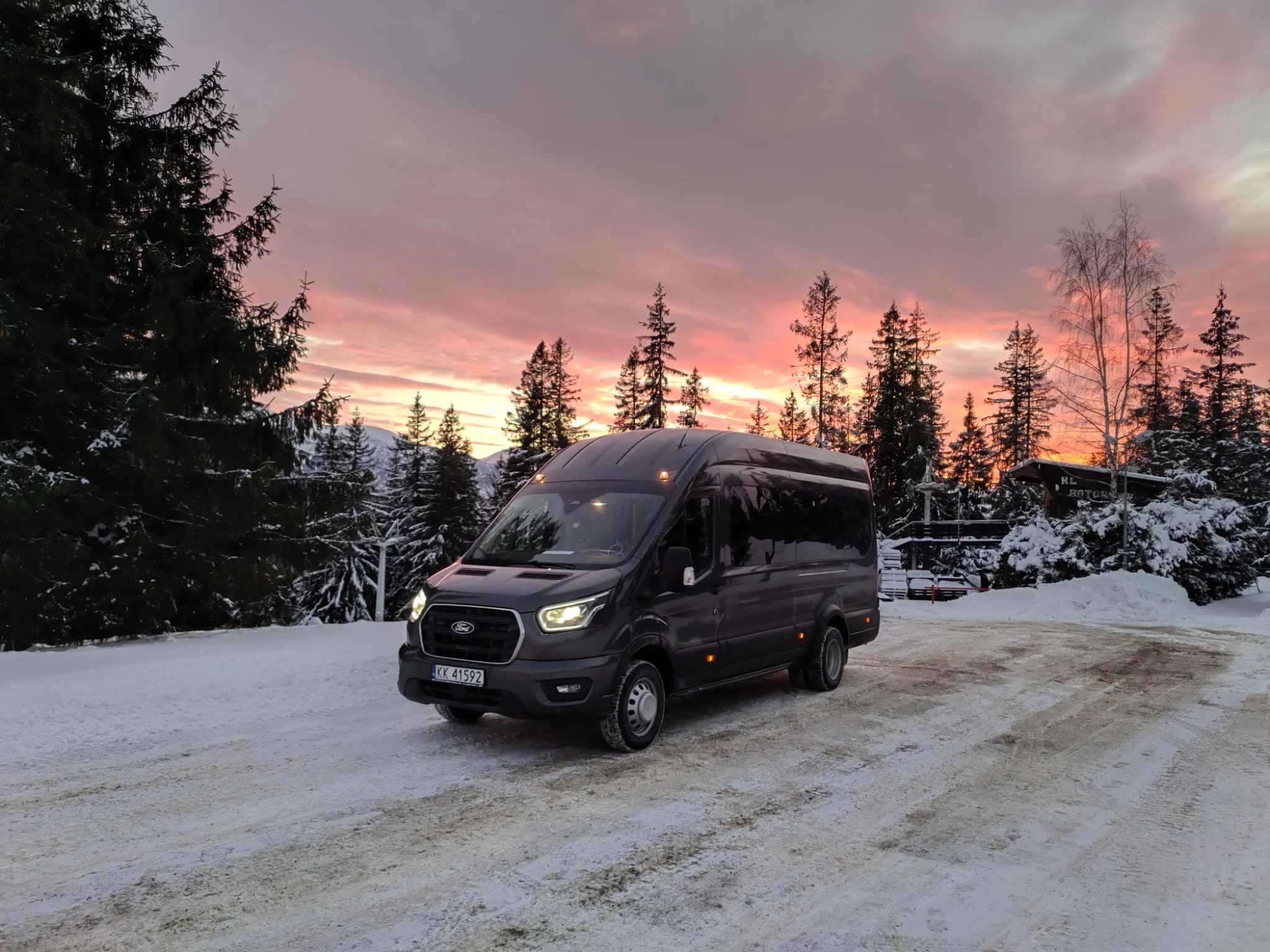 Tour minibus in the snow at sunset near Zakopane