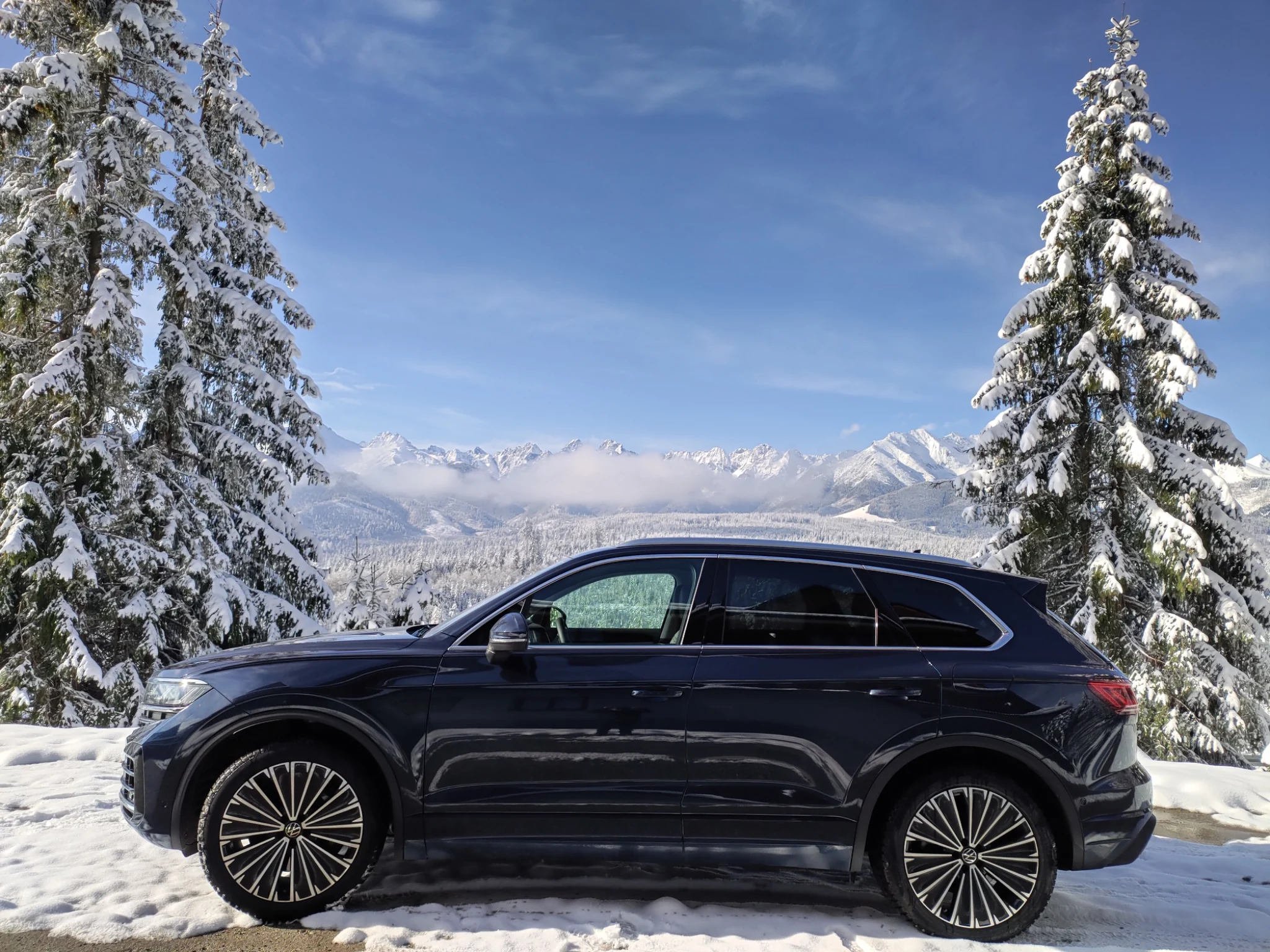 KRK tour vehicle with snowy Tatra Mountains in the background