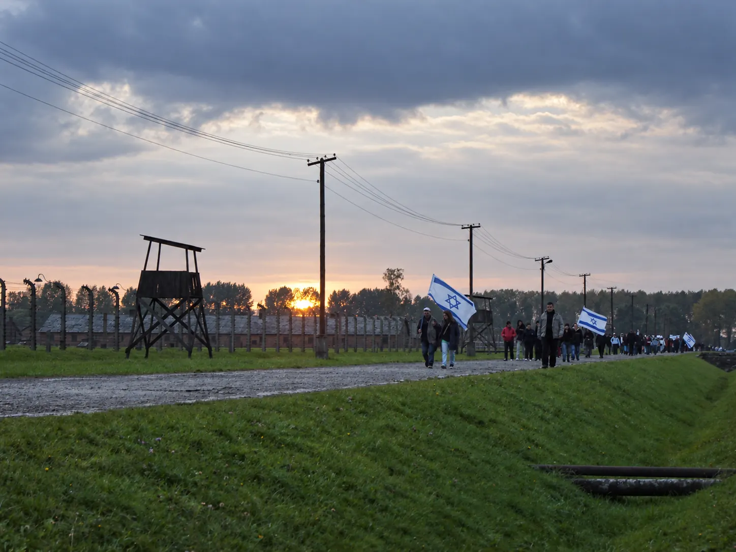 Visitors walking through the Auschwitz-Birkenau Memorial