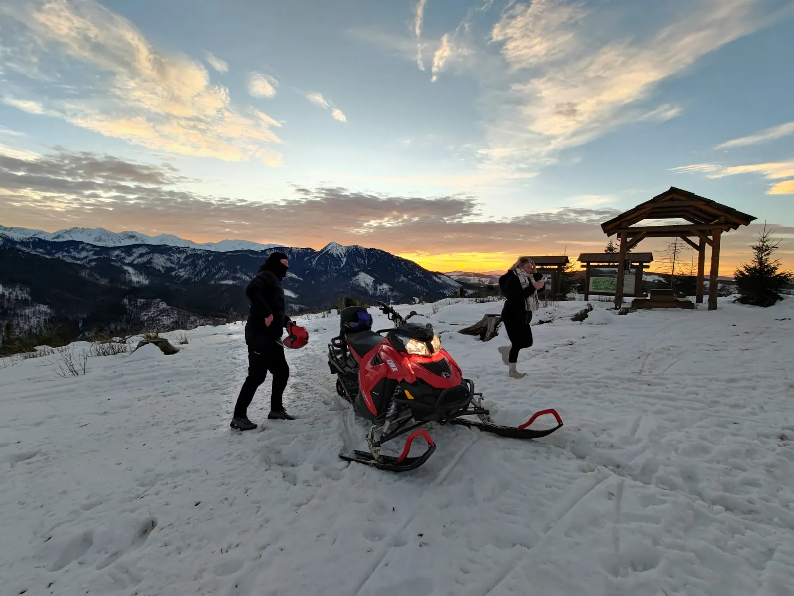 Snowmobile in the Tatra Mountains at sunset during a private winter tour
