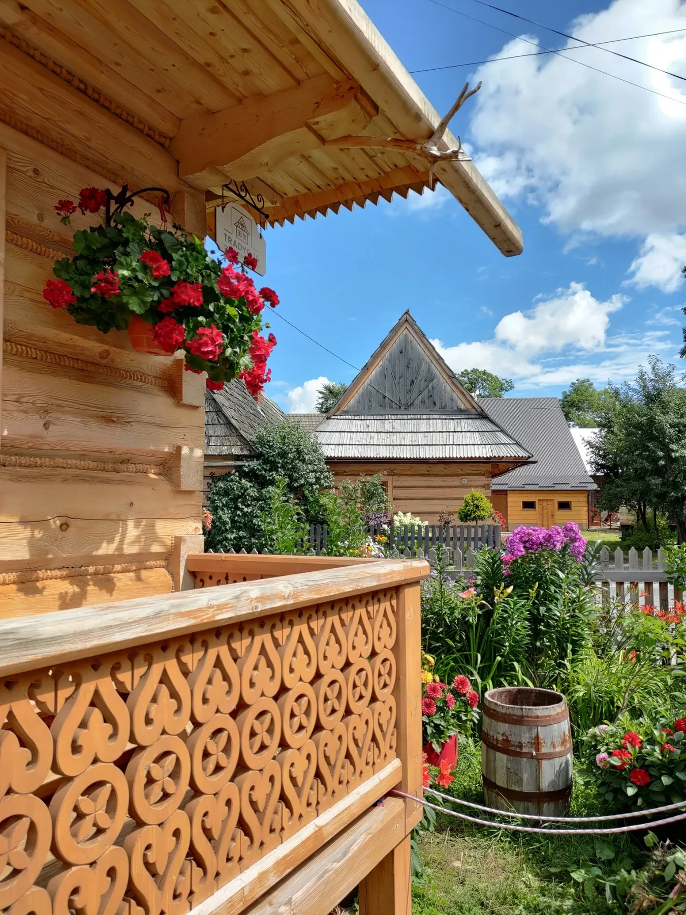Decorated wooden porch and flowers at a traditional Highlander house in Chochołów