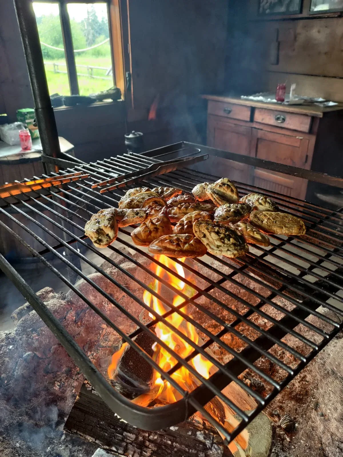 Traditional smoked oscypek cheese grilling over a fire near Zakopane
