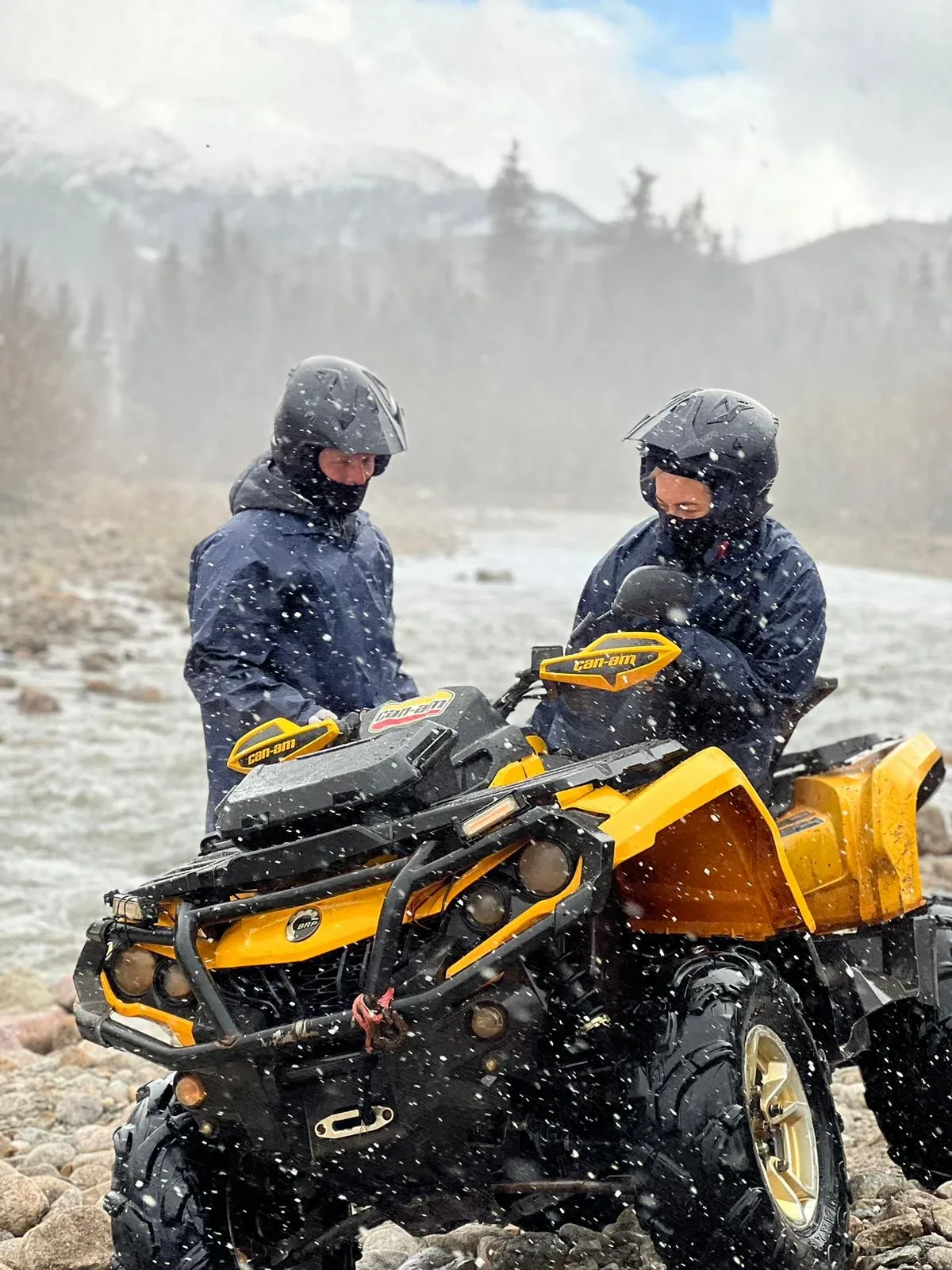 Yellow quad bike during a snowy ride in the Tatra Mountains