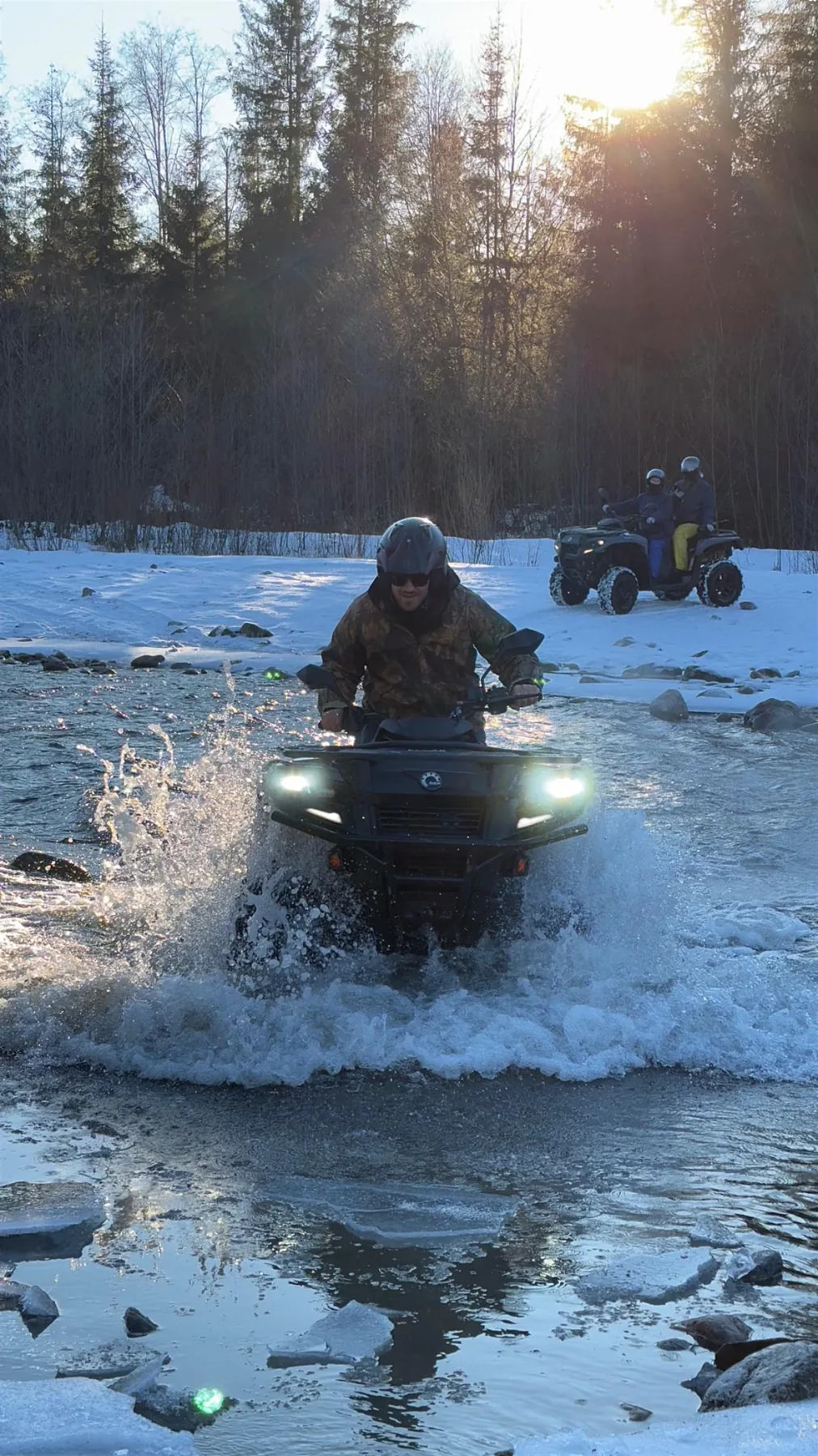 Quad bike crossing a mountain stream in winter near Zakopane