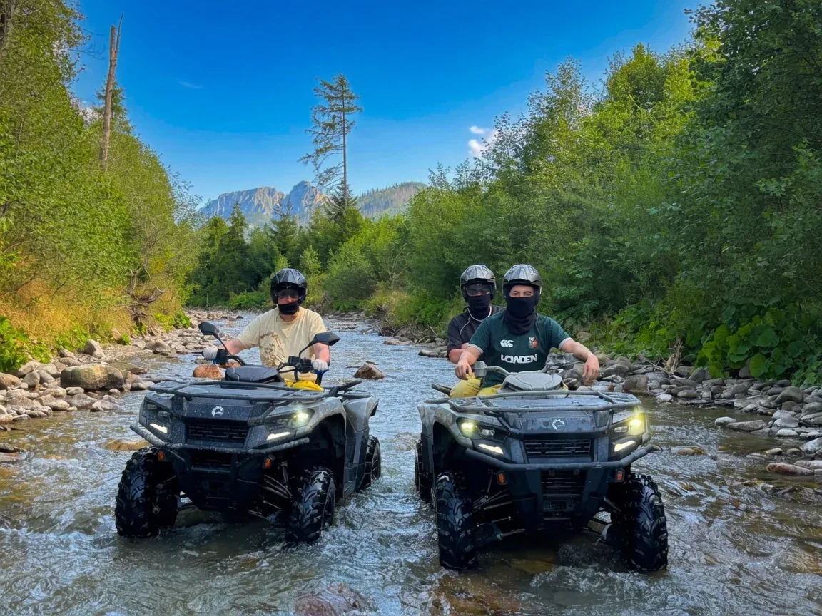 Guests riding quad bikes through a shallow mountain river near Zakopane