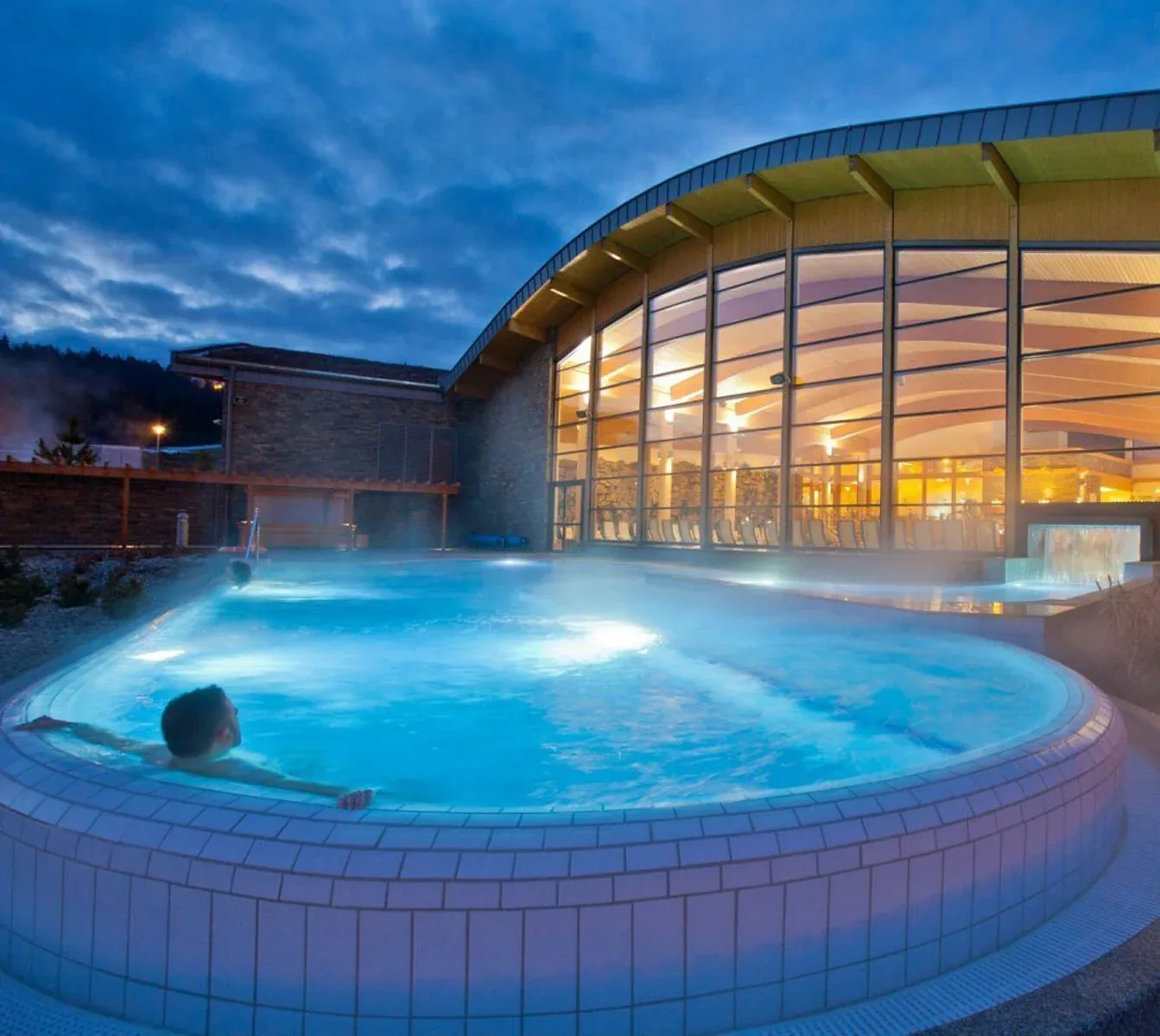 Steaming outdoor thermal pool in the Tatra region in the evening