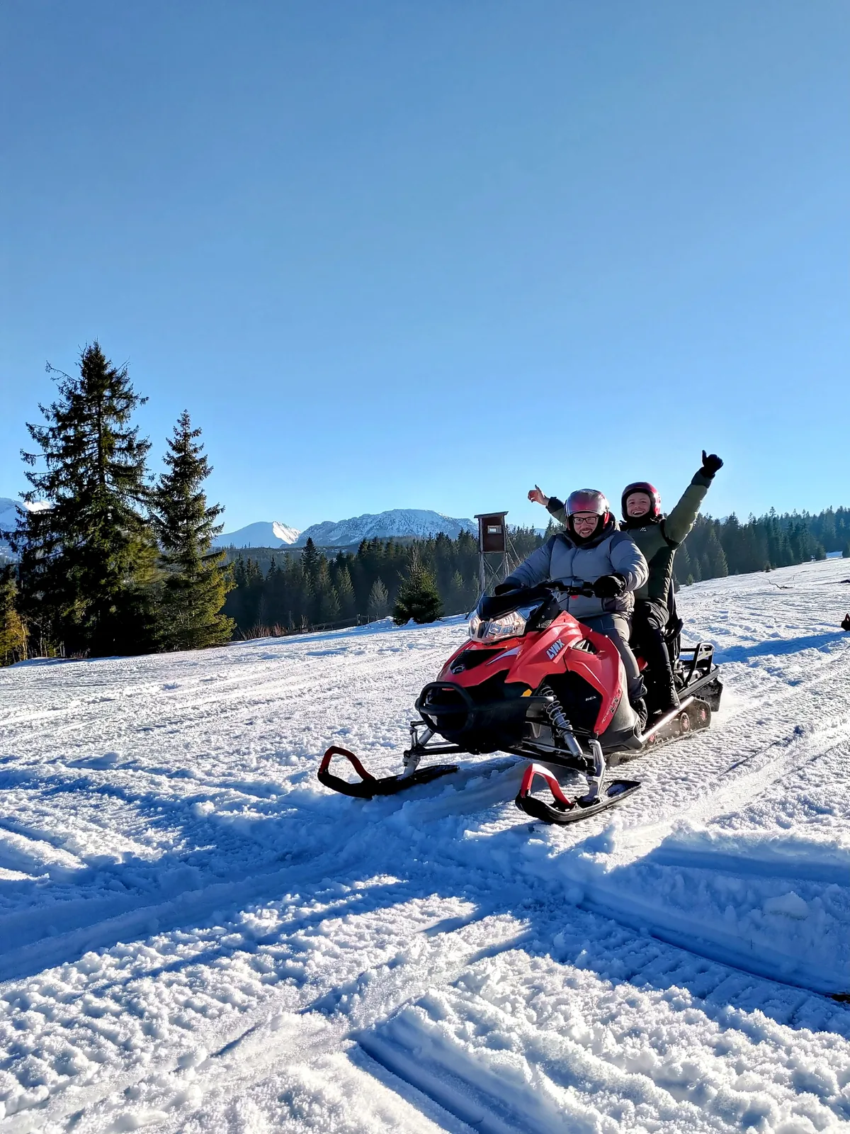 Two guests enjoying a snowmobile experience near Zakopane