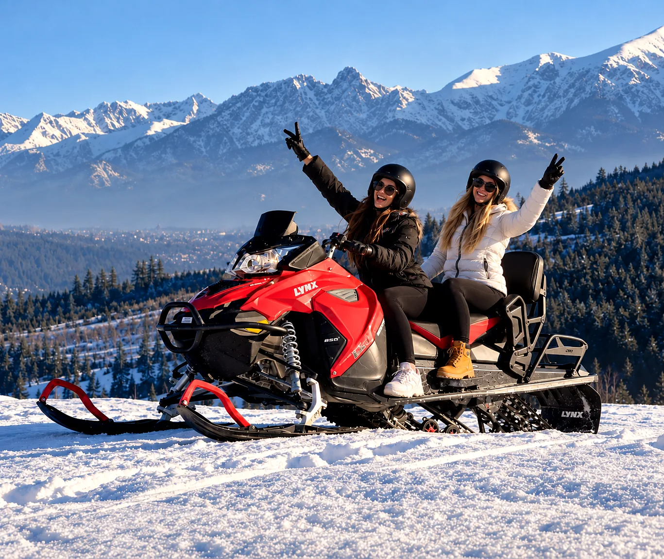 Guests on a snowmobile with the snowy Tatra Mountains near Zakopane