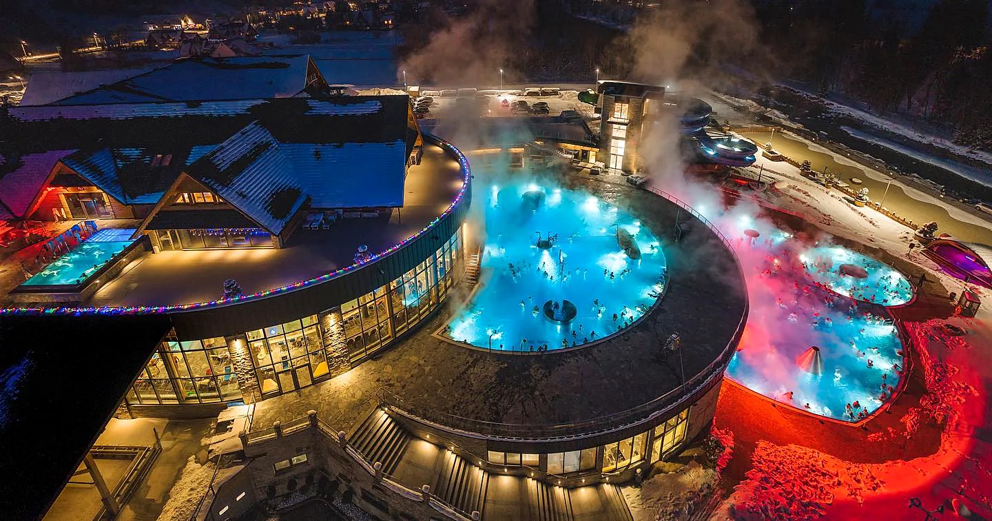 Aerial view of steaming outdoor thermal pools in winter near Zakopane