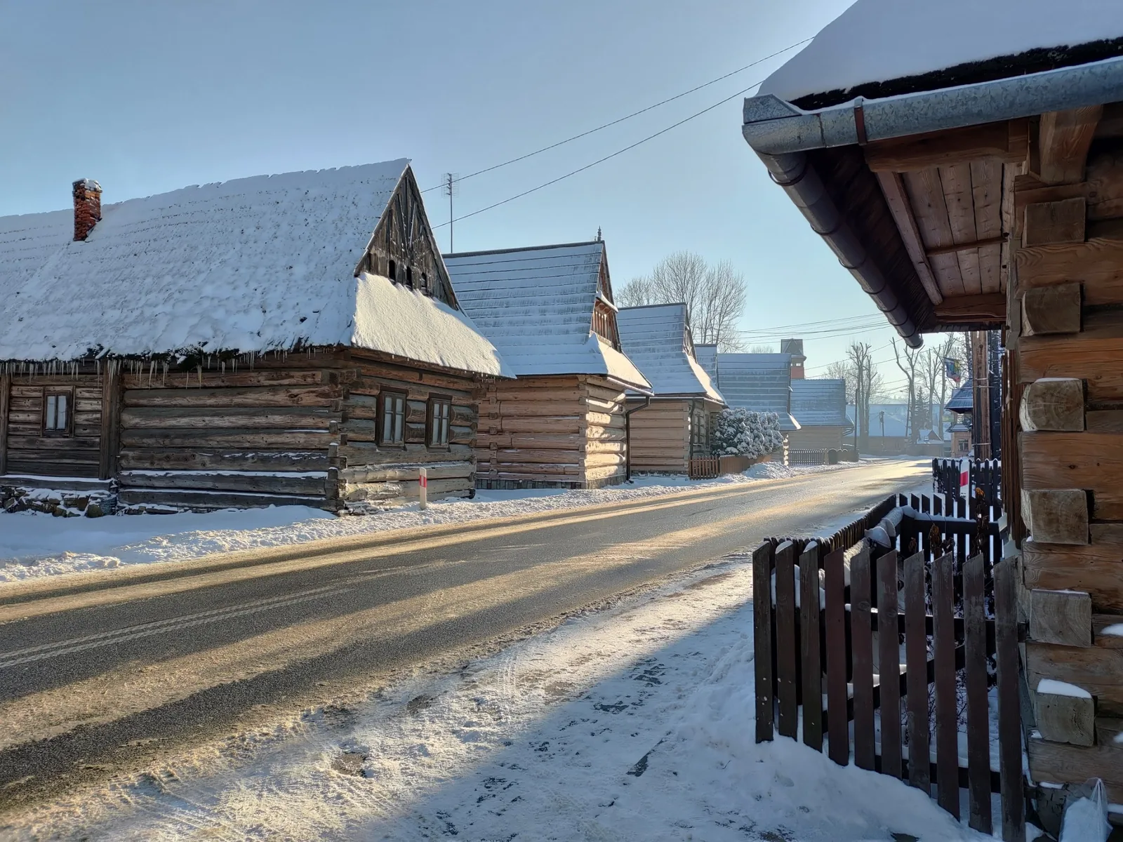 Snow-covered traditional wooden houses in Chocholow