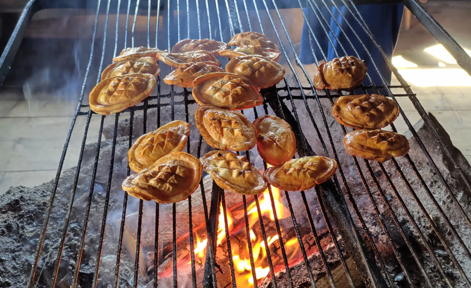 Traditional Highlander cheese grilling over a fire near Zakopane