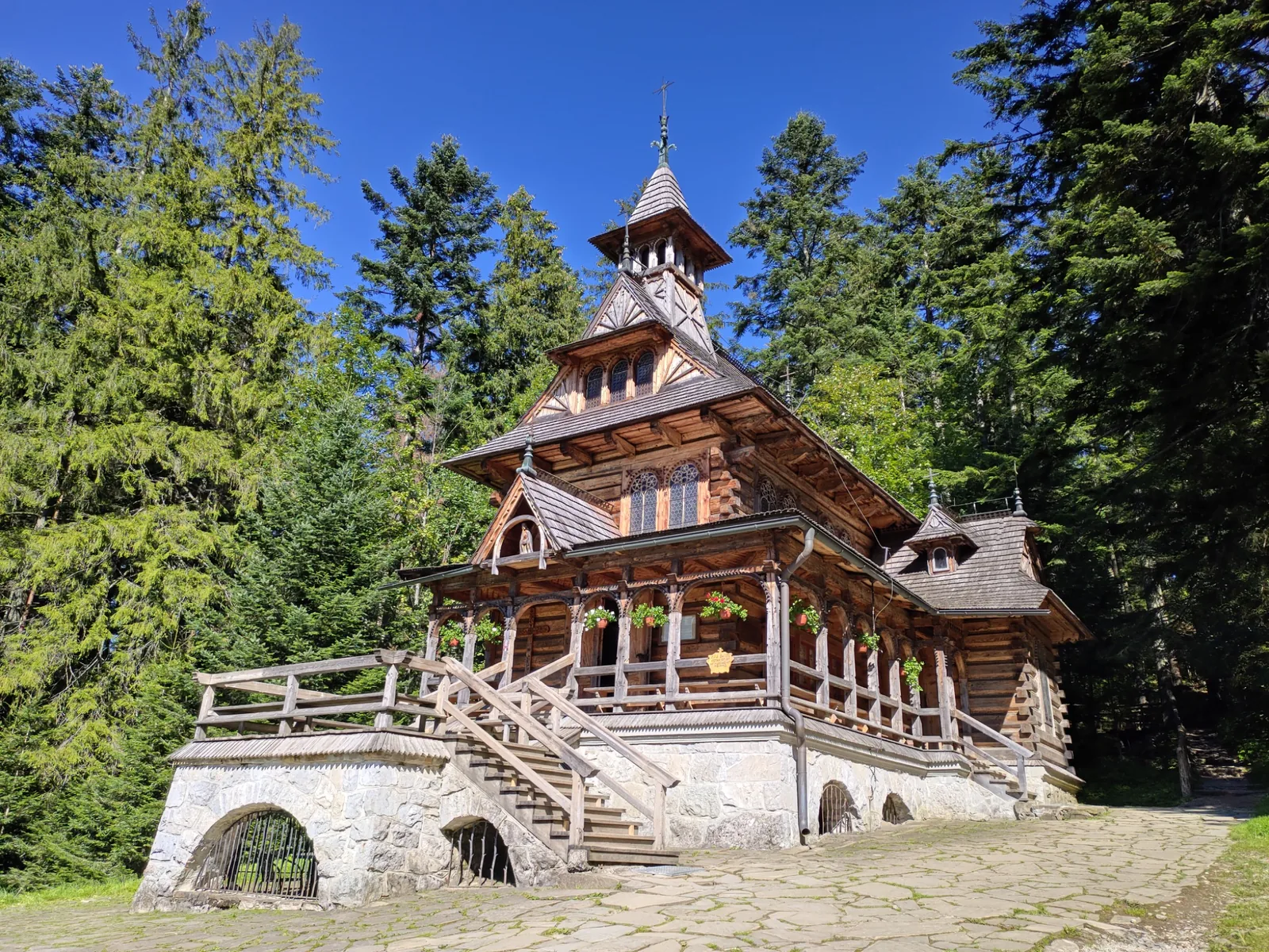 Traditional wooden chapel among trees in Zakopane in summer